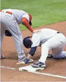  ?? GASH, ASSOCIATED PRESS AARON ?? The Brewers' Manny Pina injured his knee at first base in front of Mike Moustakas in Game 2 of the doublehead­er Thursday night.