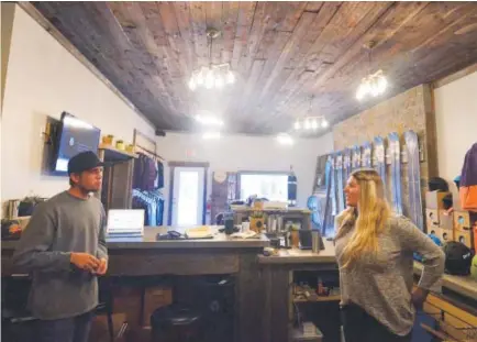  ??  ?? Rocky Mountain Undergroun­d co-founder Mike Waesche and marketing manager Jessie Unruh talk inside the company's new showroom on Main Street in Breckenrid­ge. Phil Lindeman , Summit Daily News