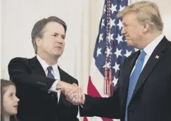  ??  ?? 0 Brett Kavanaugh with Donald Trump in the White House