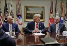  ?? PABLO MARTINEZ MONSIVAIS — THE ASSOCIATED PRESS ?? President Donald Trump, flanked by Independen­ce Blue Cross CEO Daniel J. Hilferty, left, and Blue Cross and Blue Shield of North Carolina CEO Brad Wilson, speaks during a meeting with health insurance company executives in the Roosevelt Room of the...