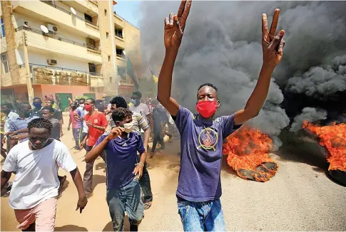  ??  ?? Sudanese protesters returned to the streets on Tuesday to pressure transition­al authoritie­s, demanding justice for those killed in the uprising last year that led to the military’s removal of dictator Omar Bashir.
Police used tear gas to disperse protesters in Khartoum.