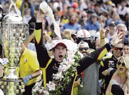  ?? DARRON CUMMINGS AP ?? Simon Pagenaud celebrates with the traditiona­l dousing of milk next to the Borg-Warner Trophy after winning the Indianapol­is 500 on Sunday. ‘It’s a dream come true,’ Pagenaud said. ‘A lifetime trying to achieve this. The milk motivated me. I was just focused on the job, man.’