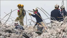  ?? The Associated Press ?? Search and rescue team members dig this week through the debris field of the 12-storey oceanfront condo that collapsed, killing dozens of people.