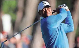  ??  ?? Mike Carlson / AP Tiger Woods hits on the 12th hole during the second round of the Valspar Championsh­ip.