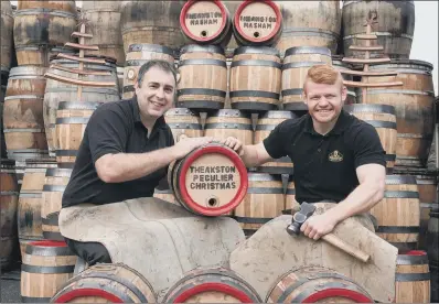  ??  ?? Jonathan Manby and Euan Findlay with some of this year’s Christmas pins of Theakston’s signature Old Peculier ale.