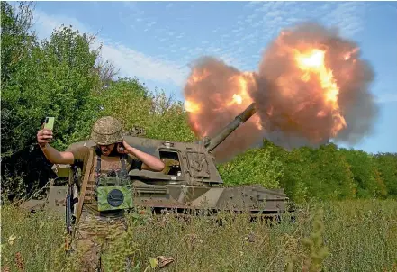  ?? AP ?? A Ukrainian soldier takes a selfie as an artillery piece fires in the front line in Donetsk region, eastern Ukraine.