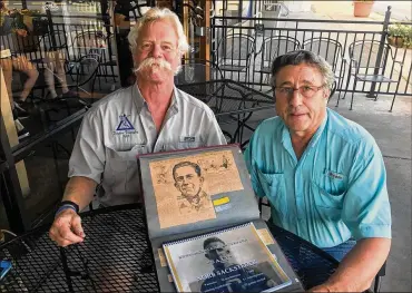  ?? TOM ARCHDEACON / STAFF ?? Kevin O’Donnel (left) and Doug Spatz with the treasured scrapbook of their great uncle, Norb Sacksteder, one of the early superstars of the fledgling NFL, the pro football years preceding it and during a celebrated college career that included the University of Dayton.