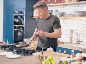  ?? JUSTIN MANDEL/AP ?? Chef, TV personalit­y and author Gordon Ramsay prepares tuna katsu in London in March. His new cookbook,“ramsay in 10,” was inspired by a series of social media videos he did making recipes in 10 minutes or less.