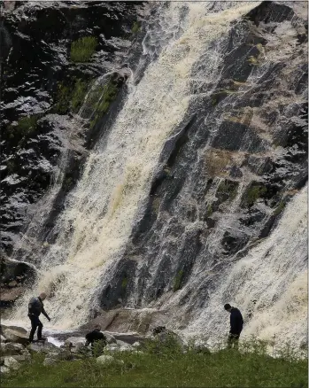  ??  ?? The search under way at the Glenmacnas­s waterfall.