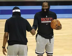  ?? The Associated Press ?? ■ Houston Rockets guard James Harden, right, talks with Los Angeles Lakers forward Markieff Morris before Tuesday’s NBA game in Houston.