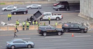  ??  ?? Three southbound left lanes were blocked Monday afternoon on I-75 at Akers Mill after witnesses reported a pickup truck fell off a bridge onto the highway. The driver of the vehicle was killed, according to authoritie­s.