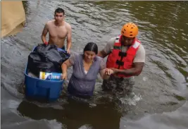  ?? Photo by Ssg. Tim Pruitt ?? Texas National Guard soldiers evacuate a family in the aftermath of Hurricane Harvey.