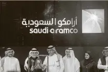  ?? Associated Press file photo ?? Officials with Saudi Aramco and the Saudi Arabian stock market are shown in Riyadh last December.