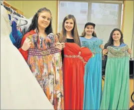  ?? CAROL DUNN/THE NEWS ?? Brooke McVicar, Shelby Kilburn, Maddie Kennedy and Kylie MacInnis, members of the Northumber­land Regional High School prom committee, show a few of the frocks they collected in order to offer low-cost dresses so that students who want to attend the...