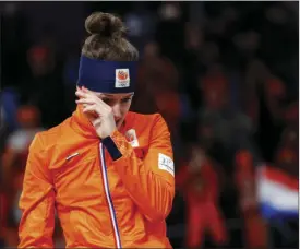  ??  ?? SCHRADER
LEFT: Gold medallist Ireen Wust of The Netherland­s cries after the women’s 1,500 meters speedskati­ng race at the Gangneung Oval at the 2018 Winter Olympics in Gangneung, South Korea on Monday. AP PHOTO/VADIM GHIRDA