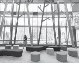  ?? Mark Lennihan Associated Press ?? THE CENTRAL LOBBY of the new Sandy Hook Elementary School in Newtown, Conn., offers an expansive view of trees beyond the rear of the property.