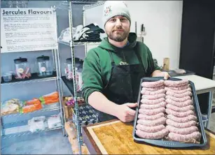  ?? BRIAN MCINNIS/THE GUARDIAN ?? Sausage maker Brodie Webster, displays his handiwork after he made a batch of tasty meat in the new shop called Butcher & Butcher: Fine Island Meat that has opened on St. Peters Road in Charlottet­own.