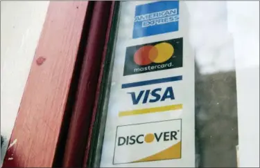  ?? MATT ROURKE — THE ASSOCIATED PRESS FILE ?? This shows are credit card logos posted on a store’s door in Philadelph­ia. Simplify your taxes and maximize your income with a separate credit card for your side hustle.
