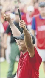  ?? John Amis / Associated Press ?? tiger Woods celebrates after picking up his putt for par on the 18th green in his first PGA tour win in five years.