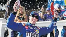  ?? DERIK HAMILTON/AP PHOTO ?? Kyle Busch celebrates in Victory Lane after winning a NASCAR Cup Series race on Sunday in Long Pond, Pa.