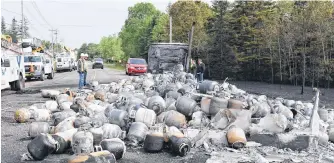  ?? HARRY SULLIVAN/SALTWIRE NETWORK ?? A tractor-trailer belonging to Supreme Tank Inc. in Sydney and carrying 1,000, 20-pound propane tanks, was destroyed after it caught fire on Plains Road in Debert on Sunday night.