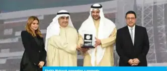  ??  ?? Sheikh Mubarak presenting a memento.