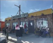  ??  ?? People wait in line for an outdoor table to open up at Crossroads Cafe, a popular Joshua Tree diner.