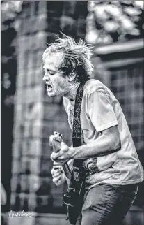  ?? RITCHIE PEREZ PHOTO ?? Christian Gagnon shreds in opening act Swellheads, before playing later with headliners Monsterbat­or in Bowring Park Thursday.