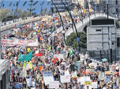  ?? REUTERS ?? Climate change protesters are seen crossing the Victoria Bridge during the Global Strike 4 Climate rally in Brisbane, Australia, on Friday.