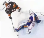  ?? The Associated Press ?? Anaheim Ducks forward Corey Perry scores the winning goal past Edmonton Oilers goalie Cam Talbot during double overtime in Game 5 of their second-round NHL playoff series in Anaheim, Calif., on Friday night.