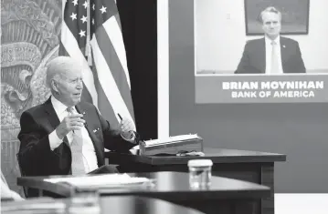  ?? SUSAN WALSH AP ?? President Joe Biden speaks about the economy during a meeting with CEOs in the South Court Auditorium on the White House complex in Washington, on Thursday. Brian Moynihan, CEO of Bank of America, appears on screen at right.