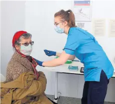  ??  ?? Jabs People have been given their first covid vaccine dose at Forth Valley College. Pictured is nurse Janette McLean with Rosemary Miller