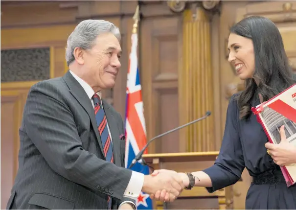  ??  ?? Winston Peters and Jacinda Ardern shake hands after signing their coalition agreement. But might new informatio­n have changed the election result?