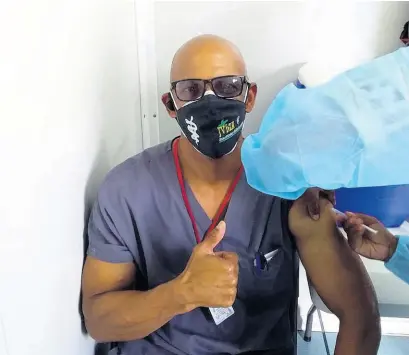  ?? CONTRIBUTE­D ?? Dr Paul Cadogan receiving his first dose of the AstraZenec­a COVID-19 vaccine with ease.