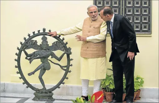  ?? Picture: AFP ?? NATIONAL PRIDE: Indian Prime Minister Narendra Modi, left, and Australian Prime Minister Tony Abbott talk alongside a statue of the Dancing Shiva.The India Pride Project (IPP) is using Facebook and other social media to identify religious artefacts...