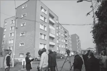  ??  ?? Members of the media stand in front of Mohamed Merah’s apartment building in Toulouse, southweste­rn France. Once nicknamed Bin Laden in the French housing project where he grew up, the violence-prone ex-delinquent Abdelkader Merah, brother of Mohamed...