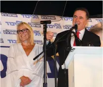  ?? (Courtesy) ?? TRANSPORTA­TION MINISTER Israel Katz speaks alongside his wife, Ronit, at his annual Sukkot party near his home in Moshav Kfar Ahim.