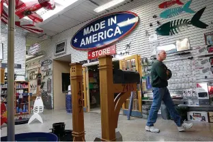  ?? Tribune News Service ?? n A customer walks through the “Made in America” store located in Elma, N.Y.