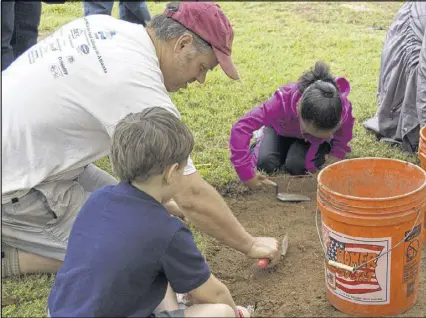  ?? CONTRIBUTE­D ?? Archaeolog­ist Scot Keith works with little excavators at last year’s Archaeolog­y Field Day.