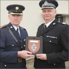  ??  ?? Garda Chief Superinten­dent Christophe­r Mangan making a presentati­on to Michael Daly, Deputy Chief Officer, Belfast Harbour Police at the official opening of the Louth Division Protective Services Unit at Castlebell­ingham Garda Station.
