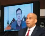  ?? Stefani Reynolds/Pool via AP ?? Sen. Cory Booker, D-N.J., listens, as James Comey, former director of the Federal Bureau of Investigat­ion, speaks virtually, left, during a Senate Judiciary Committee hearing on Capitol Hill in Washington, Wednesday.