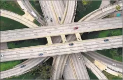  ?? Carolyn Cole Los Angeles Times ?? THE FOUR-LEVEL interchang­e, where the 101 and 110 freeways meet in downtown L.A., was mostly empty amid stay-at-home guidelines in March.