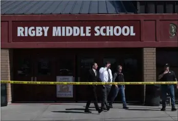  ?? John Roark /The Idaho Post-Register via AP ?? Officers leave Rigby Middle School after a shooting in Rigby, Idaho on Thursday.