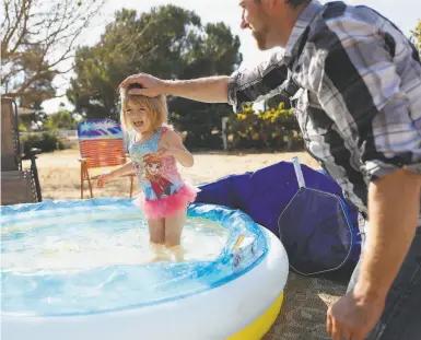  ?? Scott Strazzante / The Chronicle ?? Michael Michalske plays with his daughter, Fiona, at his inlaws’ home in San Luis Obispo County. After he was laid off from his stagehand job, he and his wife moved the family from Brisbane to save money.