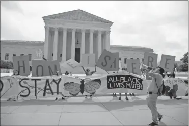  ?? Nicholas Kamm/AFP/Getty Images North America/TNS ?? Activists hold a banner in front of the Supreme Court building in Washington, D.C., on June 18, 2020.