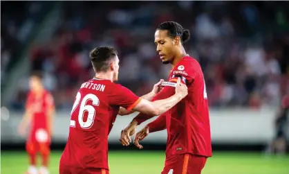  ?? City-Press/Getty Images ?? Andy Robertson puts the captain’s armband on Virgil van Dijk for the first time since October 2020. Photograph: Jan-Philipp Burmann/