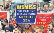  ?? PTI ?? Traders raise slogans during a protest against ‘attempts to revoke Article 35A’ in Srinagar on Wednesday.