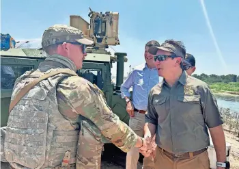  ?? PROVIDED BY GOVERNOR JEFF LANDRY’S OFFICE ?? Gov. Jeff Landry shakes hands with an unidentifi­ed Baton Rouge soldier Thursday while visiting the Louisiana National Guard troops deployed to the U.S. southern border in Texas.