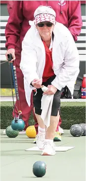  ?? ?? A raincoat was a must as Trafalgar second Heather Taylor bowls at Drouin during Saturday’s division one game.