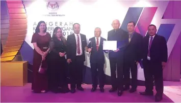  ??  ?? Nyuak (centre) and Anthony (third left) hold the award in a photo call with other Cita officials following the ceremony.